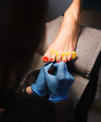 Master does pedicure for client. Pedicure process.