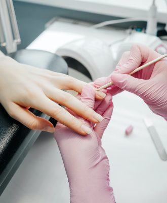 Young woman getting manicure in beauty salon